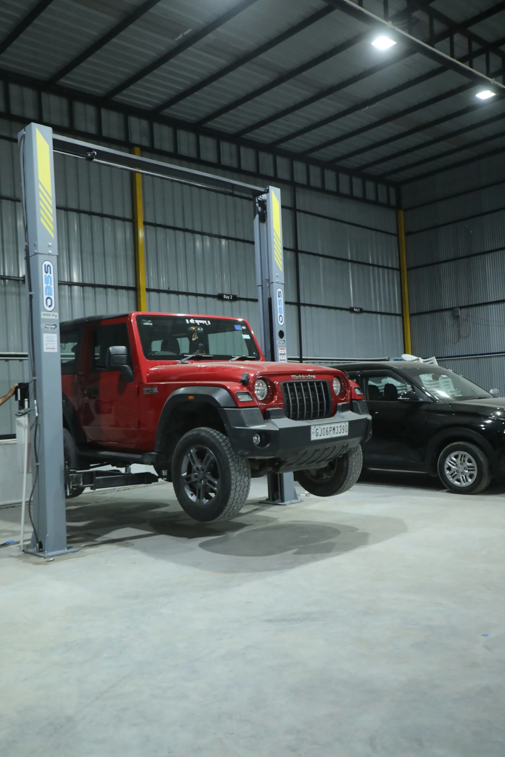 Auto Touch Cars luxury SUV servicing and car maintenance workshop with hydraulic lift