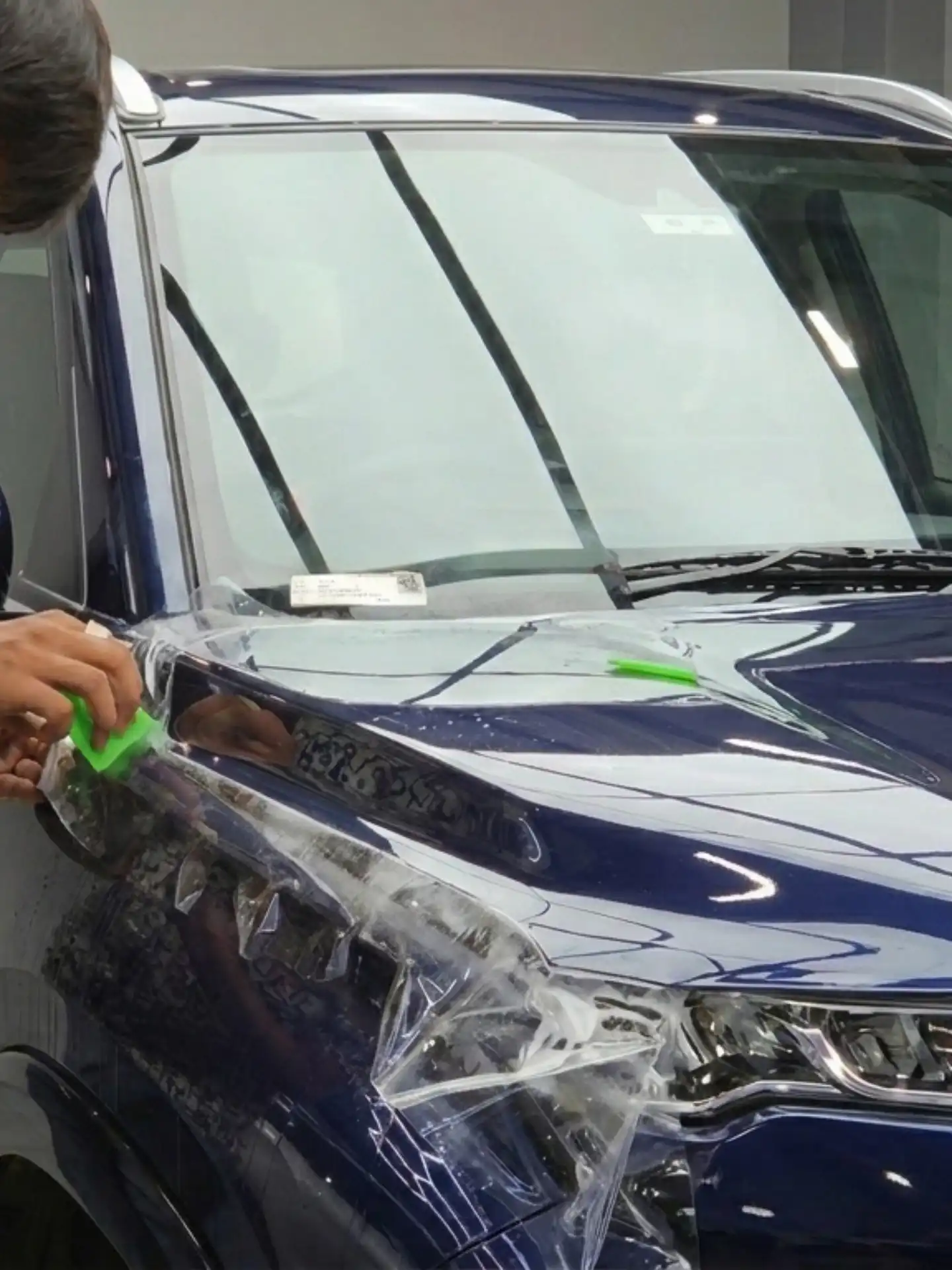 PPF installation on blue SUV car for paint protection film coating and scratch protection